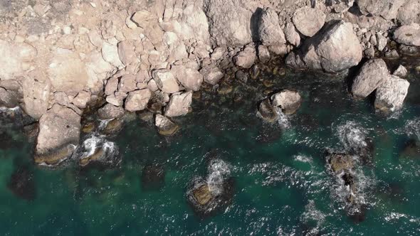 Tidal Bore Roaring Near Rocky Ocean Coastline Waves Splashing with White Foam alt