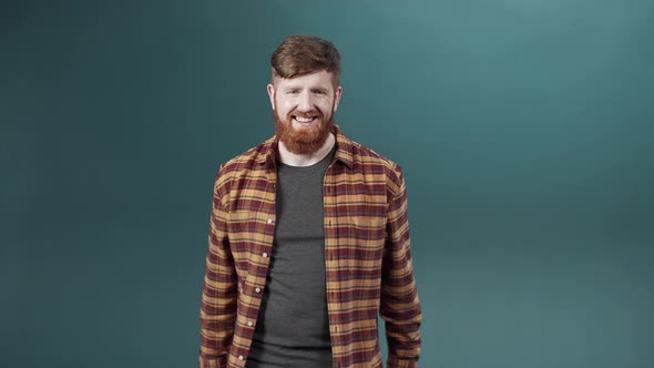 A Red Bearded Man Takes Off His Mask Throws It Away and Shows That He is Pleased with That