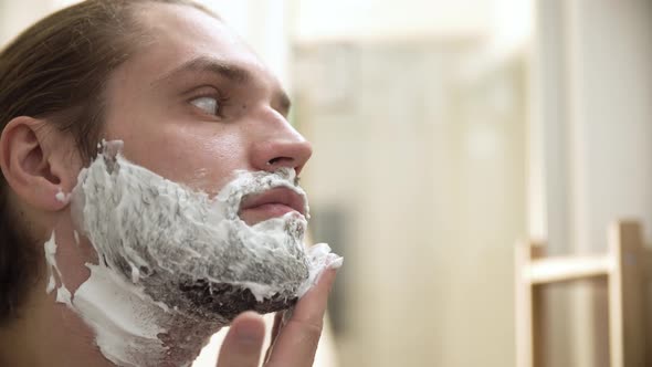 Men Hygiene. Male Applying Shaving Foam On Beard Closeup alt