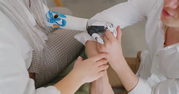 The girl with the bionic hand is holding the guy's hand Bionics Cybernetic Robotic-arm alt