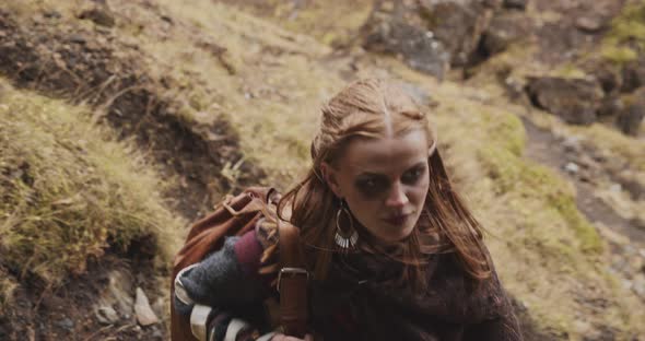 Woman Carrying Bag Up Mountain Path alt