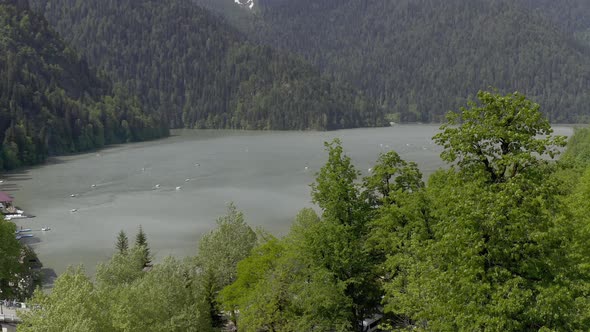 Aerial Shot Beautiful Lake Surrounded By High Natural Mountain Covered By Trees with Catamarans alt