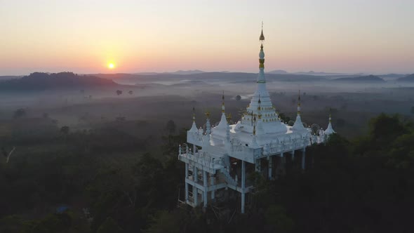 Aerial view of Khao Na Nai pagoda stupa. Luang Dharma Temple Park with green mountain hills alt