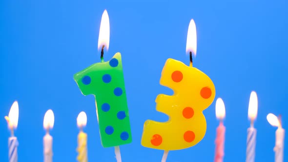 Light the Candle Number 13 for Birthday on Blue Background alt