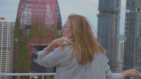 Young Woman Watching the View From Skyscraper