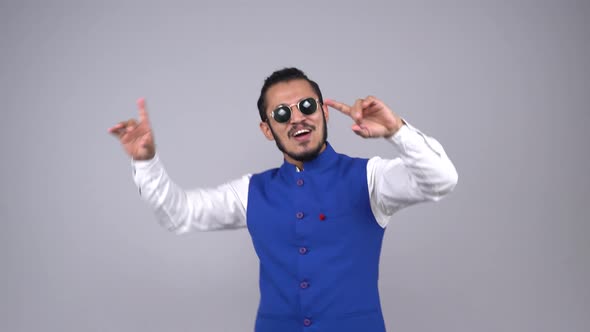 Happy young Indian young man dancing and doing bhangra alt