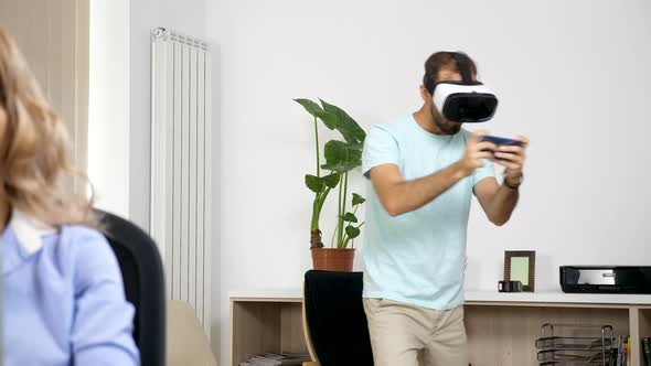 Man Plays Virtual Reality Games in the Living Room While Her Girlfriend Tries To Work on the alt