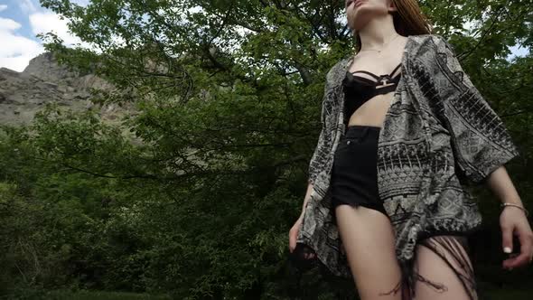 Beautiful Girl in a Short Top and Summer Cape Goes Down Right on Camera