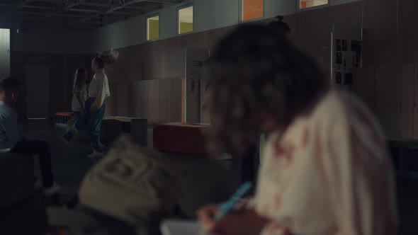 Teen Girl Writing Down Notes in Sketchbook Sitting School Corridor Close Up alt