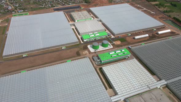 Aerial View of Huge Areas of Greenhouses for Growing Vegetables alt
