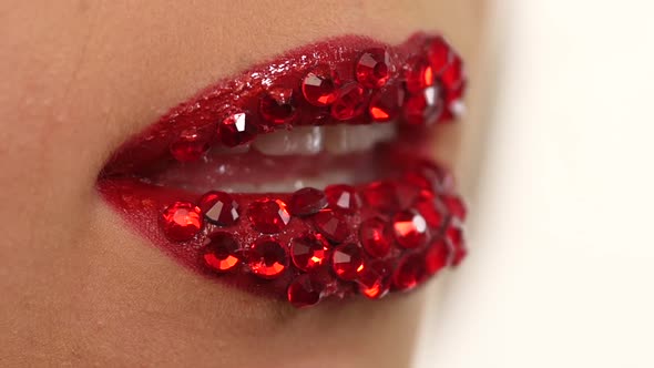 Sexy Woman with Red Rhinestones on Her Lips. Slow Motion. Close Up alt