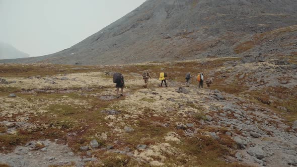 Aerial View of Group of Friends in Hiking in Mountains alt