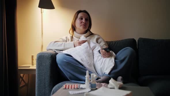 Ill Woman at Home Sitting on Sofa Sneezing Watching Tv Female Having Runny Nose alt