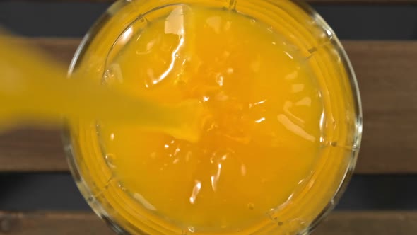 Orange Juice Pouring in Glass. Healthy Nutrition. Glass of Orange Juice alt