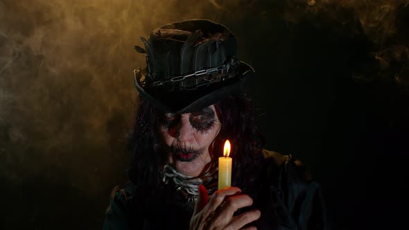 Sinister Old Mature Woman in Carnival Costume of Halloween Witch Making Magic Rituals with Candle alt