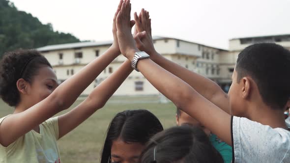 Kids Playing London Bridge is Falling on the Playground. alt
