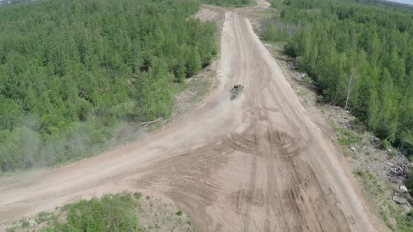 Armoured vehicle on country road, aerial view alt