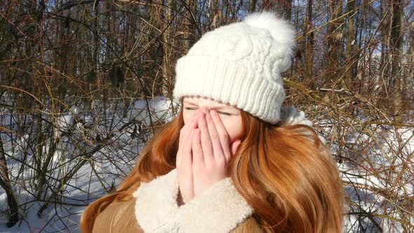 Ginger-Haired Girl Is Breathing On His Frozen Hands In The Cold