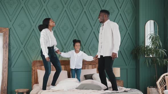 Happy Family African American Young Parents and Caucasian Daughter Baby Girl Child Holding Hands alt