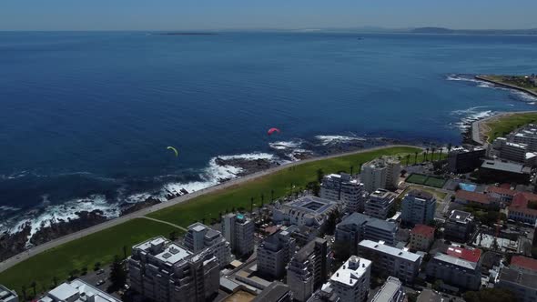 Drone shot of Sea Point, Cape Town - drone is flying over the boulevard, watching the ocean and some alt