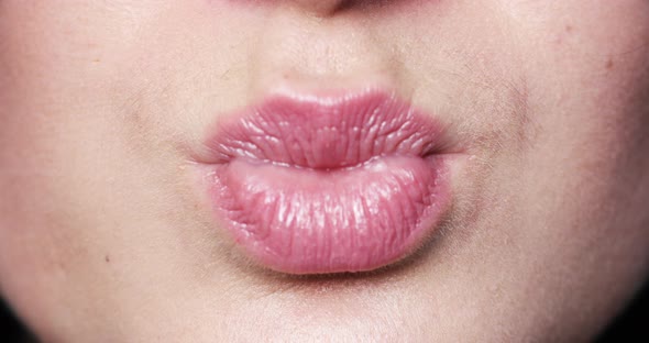 Woman's Lips Kissing in Close-up