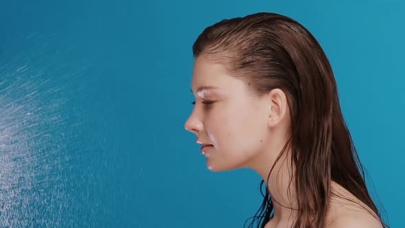 Profile Shot of Woman with Naked Shoulders and Wet Hair Getting Water Splashes From Side alt