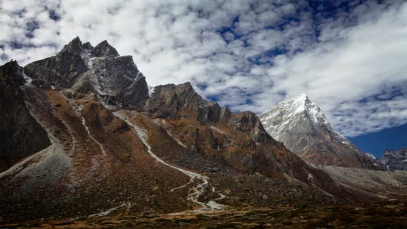 Time-lapse of rocky Himalayan peaks and passing clouds alt