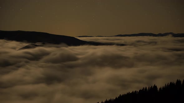 Loop Time Lapse of Fog and Stars over Mountains 