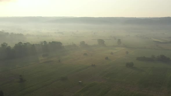 Misty morning over the agricultural land in the valley 4K drone video alt