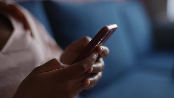 Closeup Cropped Shot of Unrecognizable AfricanAmerican Woman Sitting on Blue Sofa Using Typing on alt