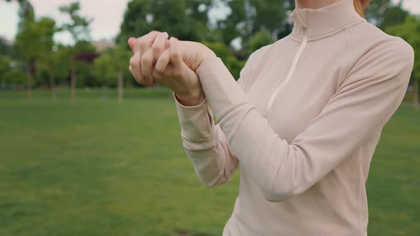 Warming up wrist joints of a woman's hands. alt