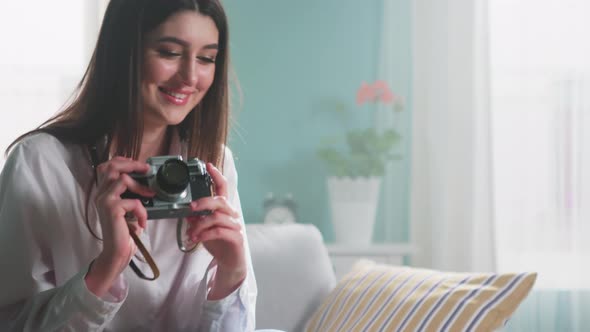 Woman Is Showing Retro Camera
