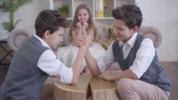 Focus Changes From Twin Brothers Competing in Armwrestling To Cute Caucasian Girl Cheering at the alt