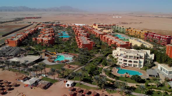 Flying from above over the hotel and the desert near Hurghada. alt