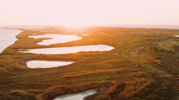 Aerial View of Lakes and Islets Near Black Sea on Backdrop of Summer Sunset. Stunning Flight Over alt