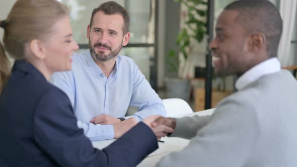 Successful Mixed Race Business People Shaking Hands in Agreement alt