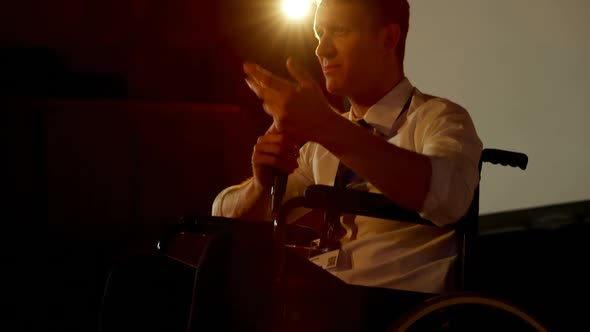 Young Caucasian disabled businessman speaking in business seminar in auditorium 4k alt