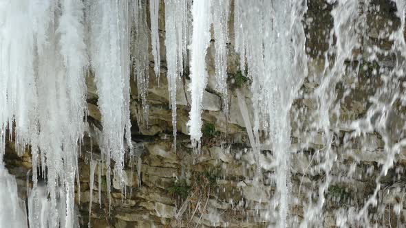 Waterfall and icicle on a stone surface in Niagara Escarpment in Hamilton alt