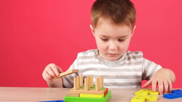 Little Boy Plays in Developing Game, Education and Daycare Concept alt