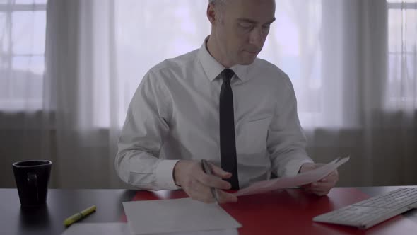 Man Going Over a Proposal at Work alt