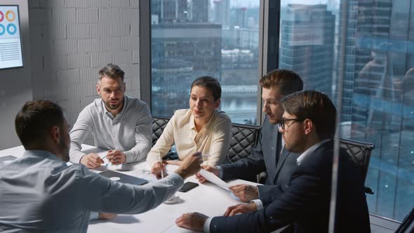 Teamwork of businessmen in a discussion at a meeting in a modern office alt