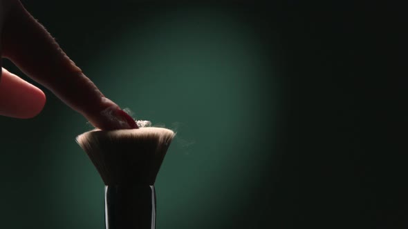 Slow Motion Of Makeup Powder Flying In The Air From A Brush A Concept Of Beauty On A Green alt