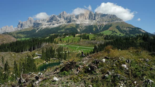 Girl on the Top of Hill with View of Uprooted Pine Trees After Strong Wind in Lake Carezza Most alt