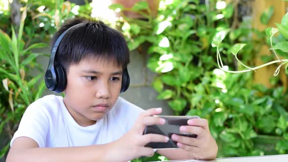 The Boy Playing A Game On Smartphone