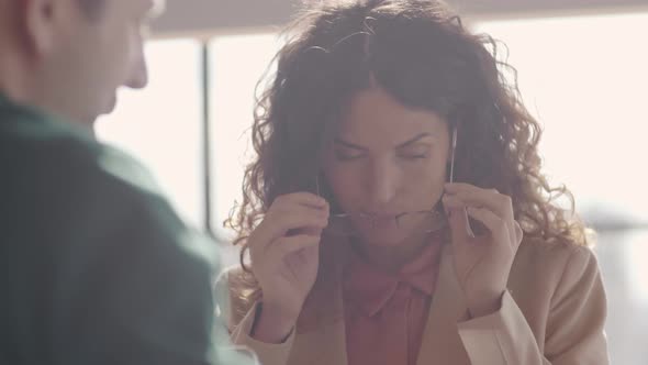 Pair of Businesspeople Looking Through Documents alt