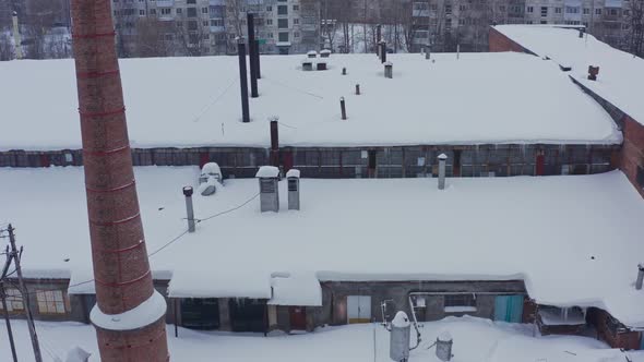 Brick Facade of the Industrial Building Against the Background of the Winter Landscape