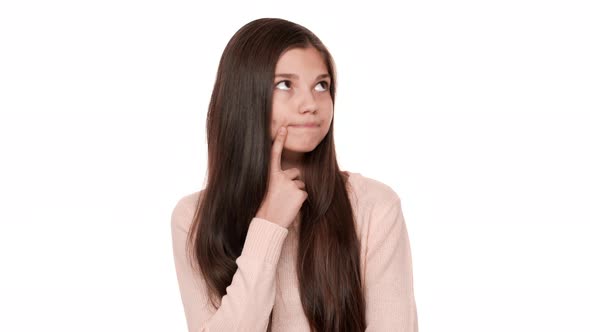 Portrait of Serious Brunette Adult Girl 20s Holding Index Finger on Cheek Thinking Hard Trying to alt