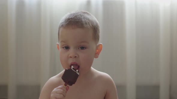 Naked Caucasian Baby Boy Eating Licking Icecream in Livingroom Hot Sunny Day, Stock Footage