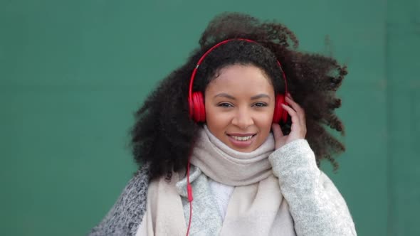 Young African American Woman is Listening Music and Having Fun Outdoors Spbi alt