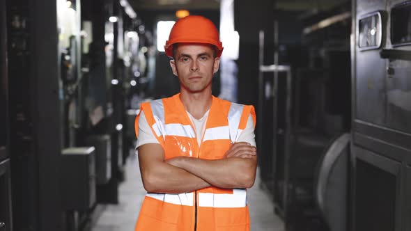 Portrait of an Engineer Man or Worker Crossing Arms Working in Electrical Room Station alt
